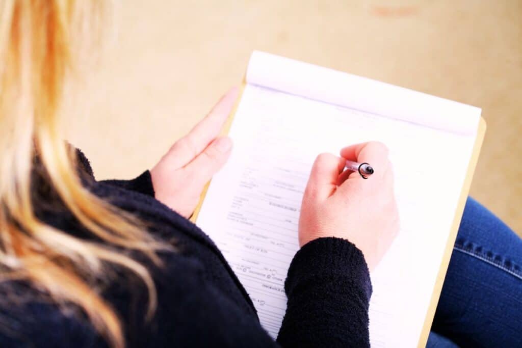 Female filling out a DBS check form