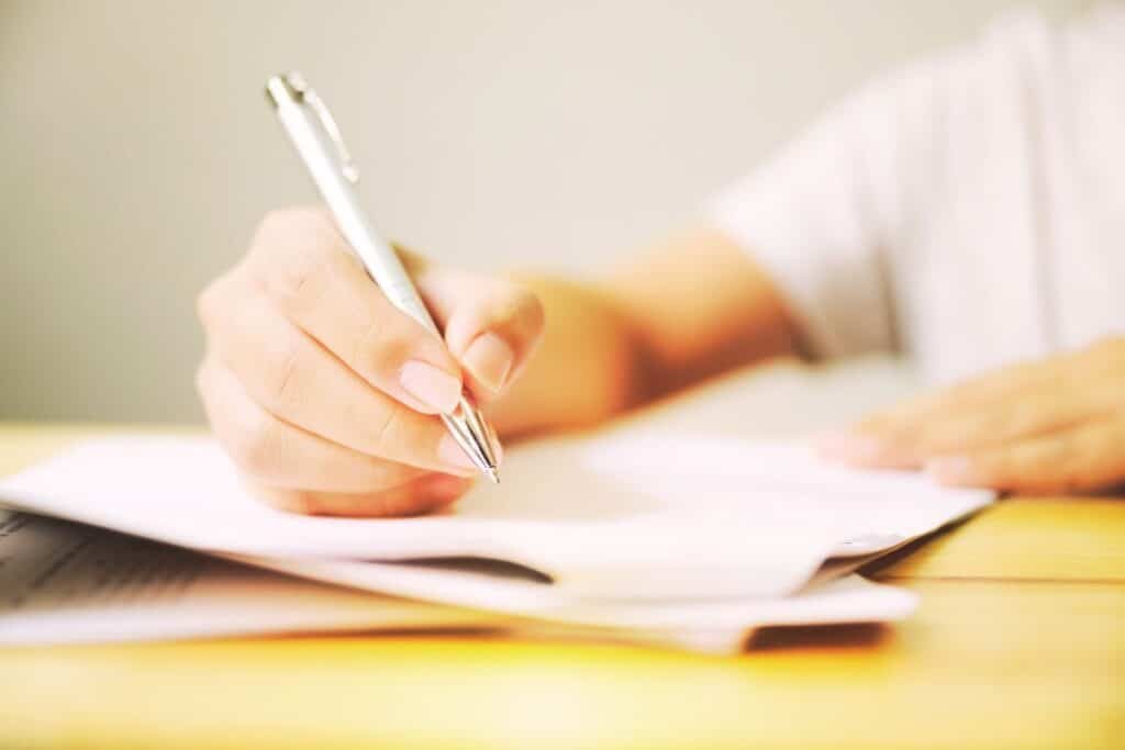 Person filling out a form which could be a DBS check