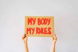 my body my rules written on a piece of cardboard and being held up as a sign about consent